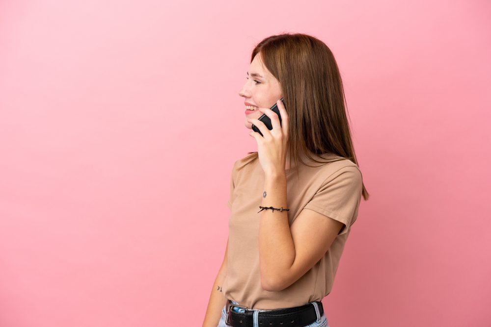 Young,English,Woman,Isolated,On,Pink,Background,Keeping,A,Conversation Young,English,Woman,Isolated,On,Pink,Background,Keeping,A,Conversation